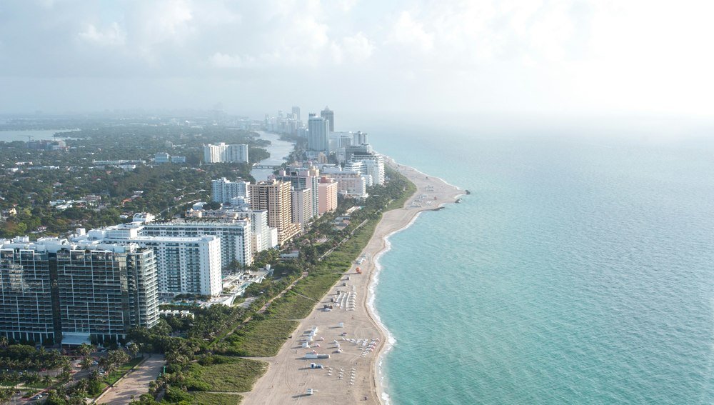 Aerial view of a Florida coastline lined with high-rise condominium buildings