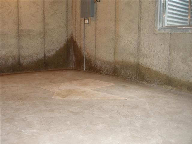 Water intrusion staining on an interior concrete wall