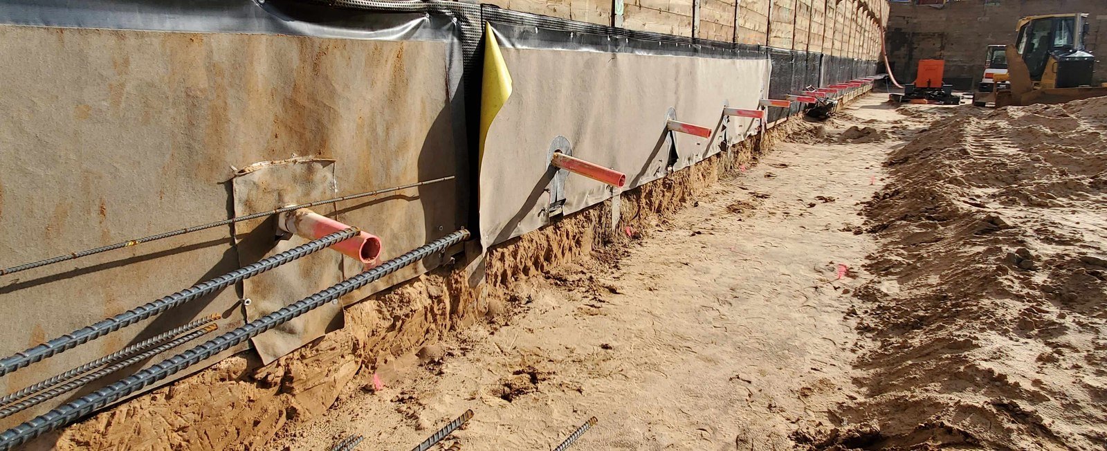 Excavation shoring wall with waterproofing membrane installation